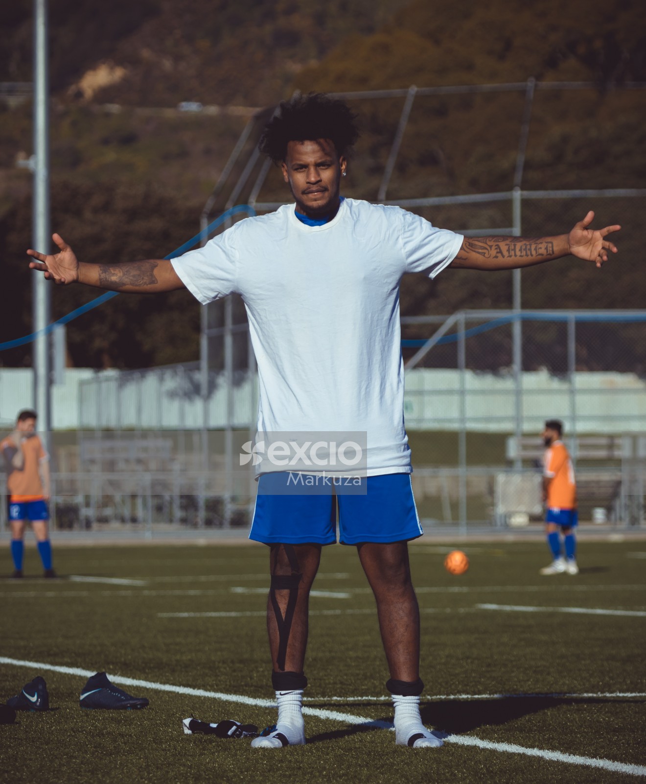 Tattooed football player in white shirt - Sports Zone sunday league