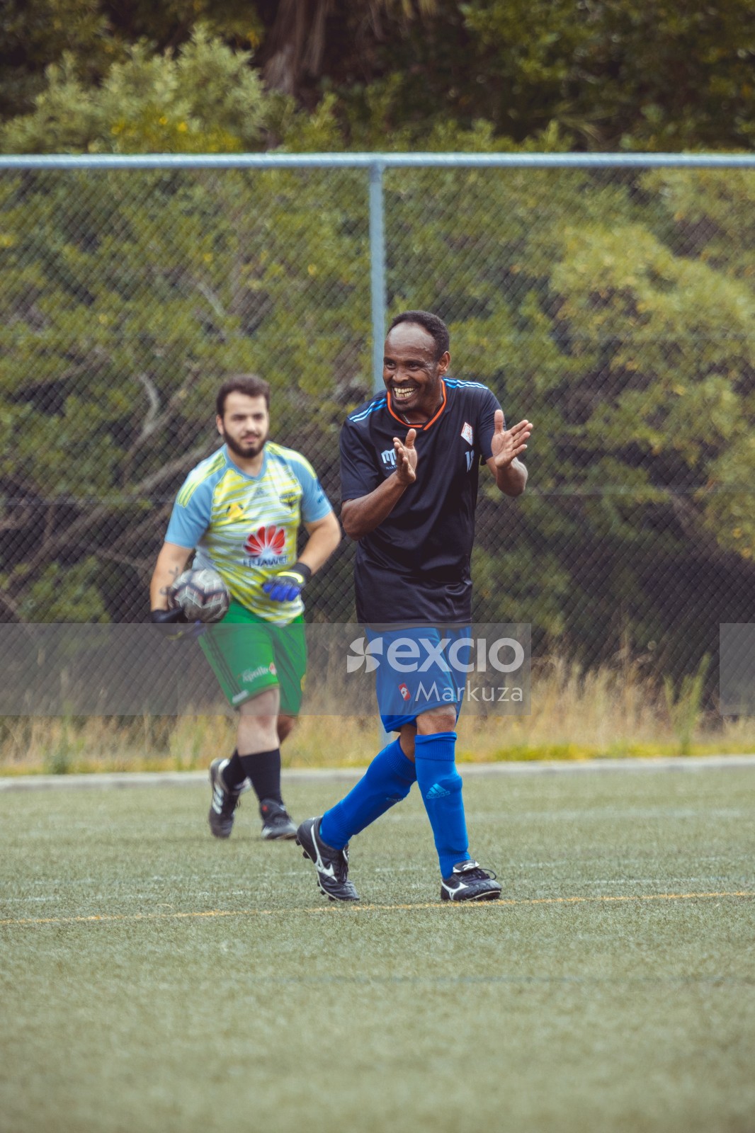 Football player in black shirt clapping - Sports Zone sunday league