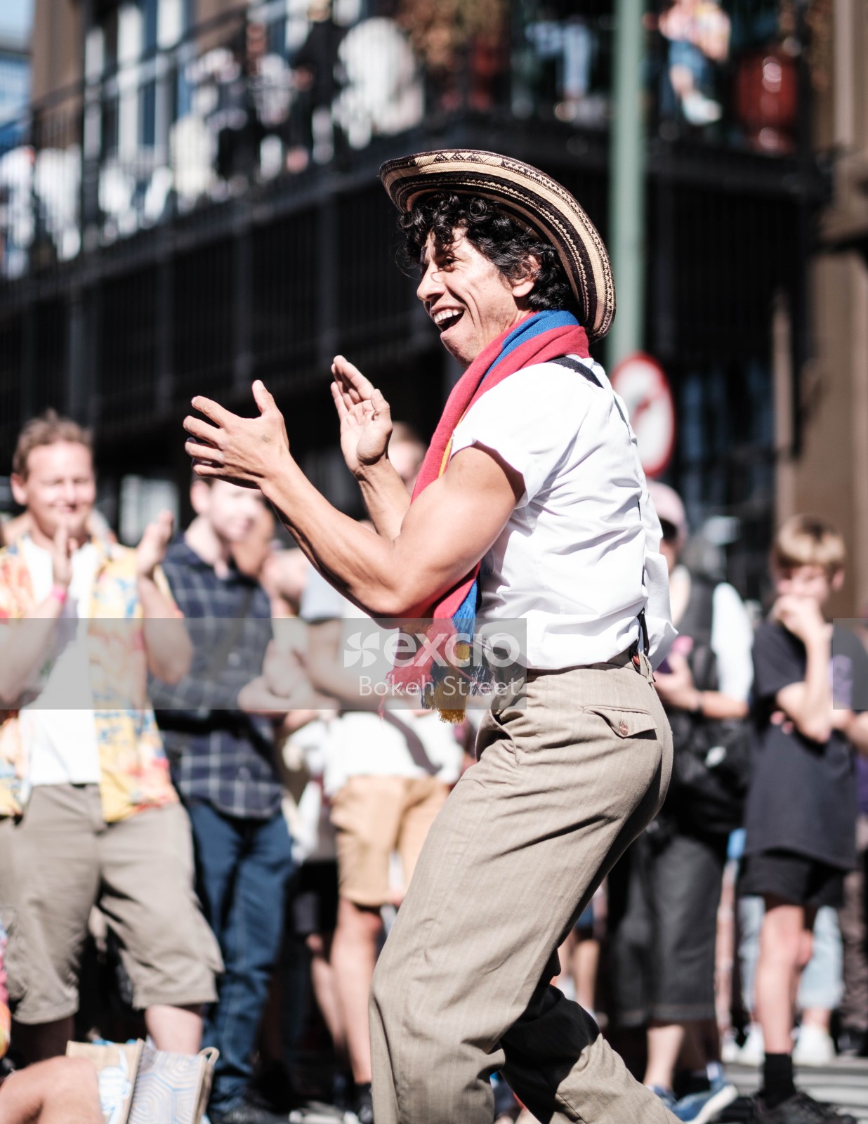 Curly haired muscular man dancing in the street at Cuba Dupa 2021 bokeh