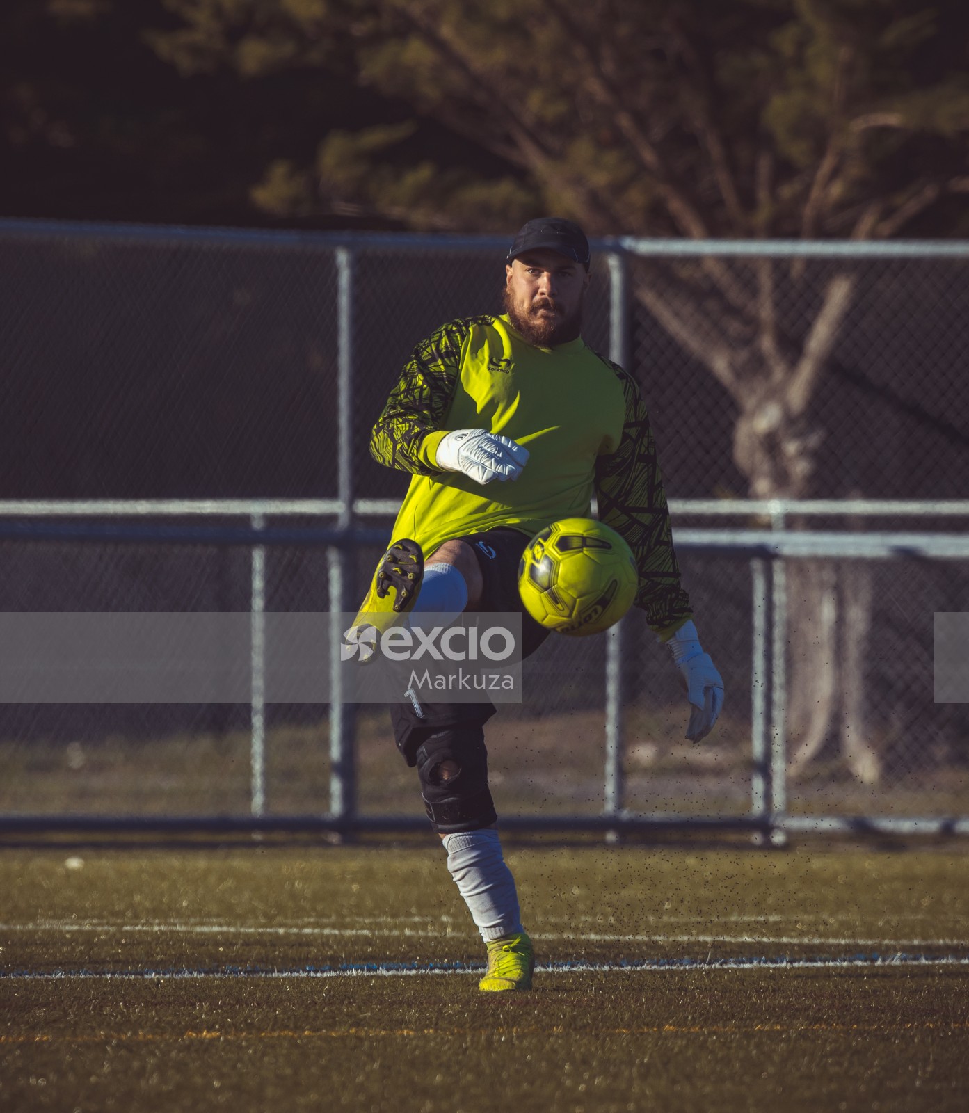 Goalkeeper kicks neon yellow football - Sports Zone sunday league