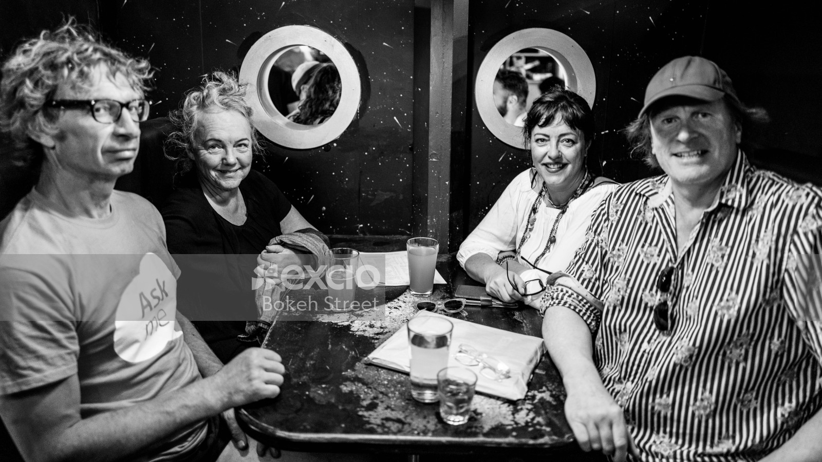 2 couples at a table at Newtown festival 2021 monochrome
