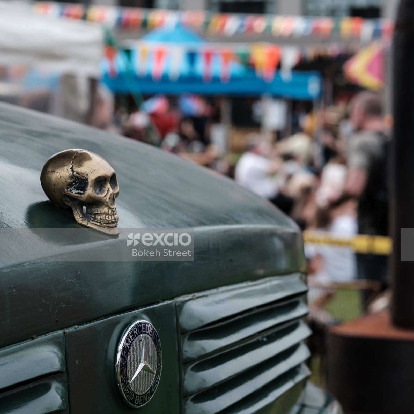 Skull hood ornament on a green Mercedes Benz truck