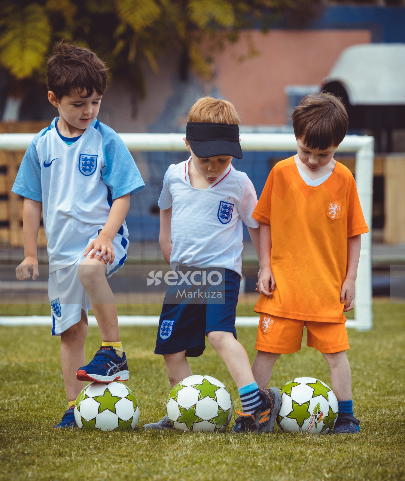 Three boys posing with their footballs - Little Dribblers