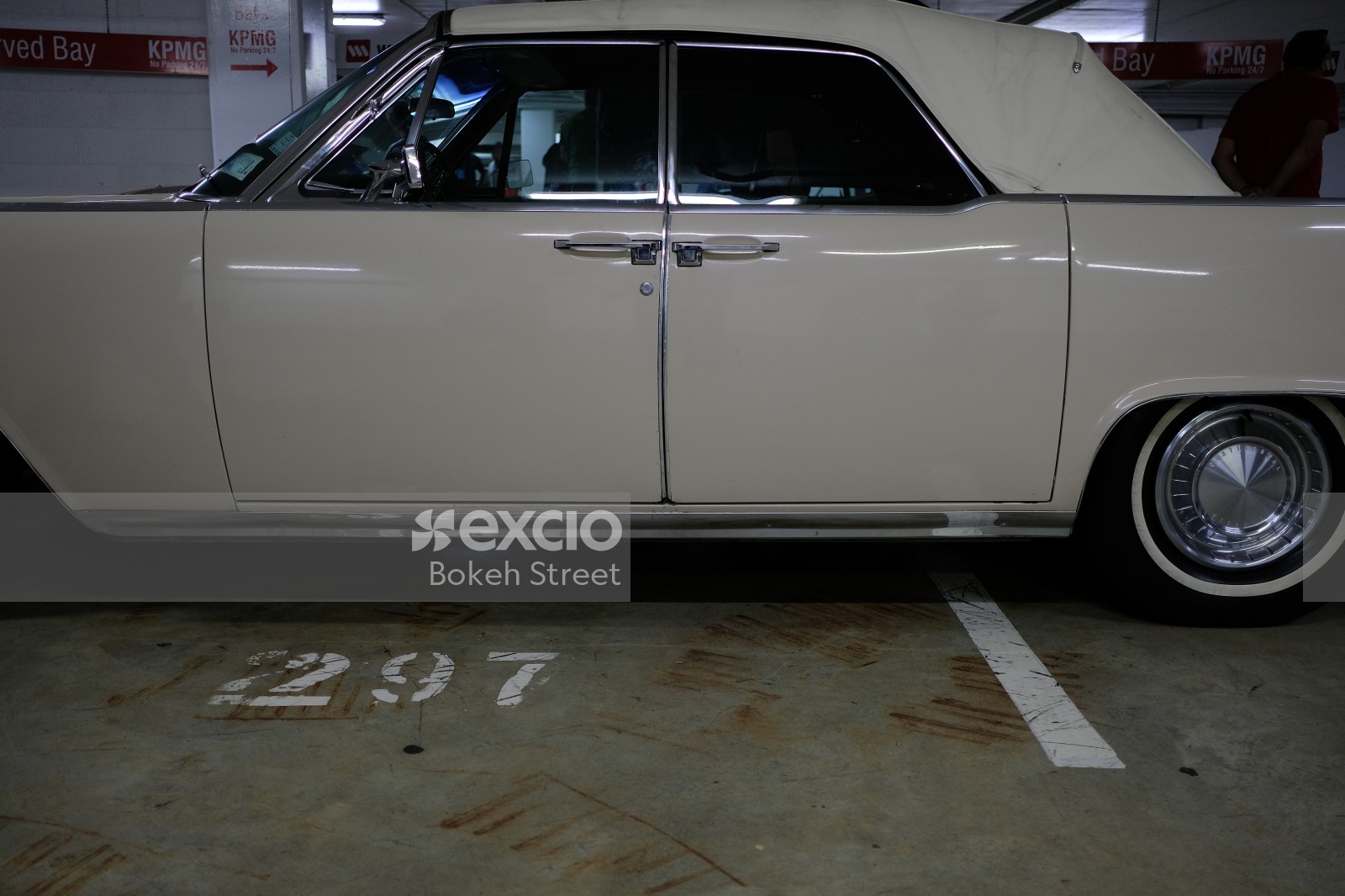 Classic white Lincoln Continental with soft top and suicide doors