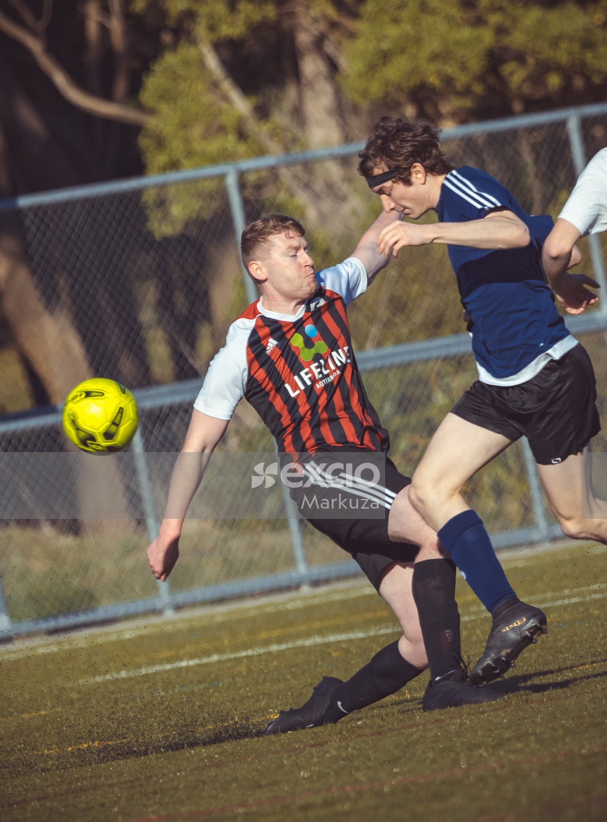 Super Paddys FC player tackling opponent from the front - Sports Zone sunday league