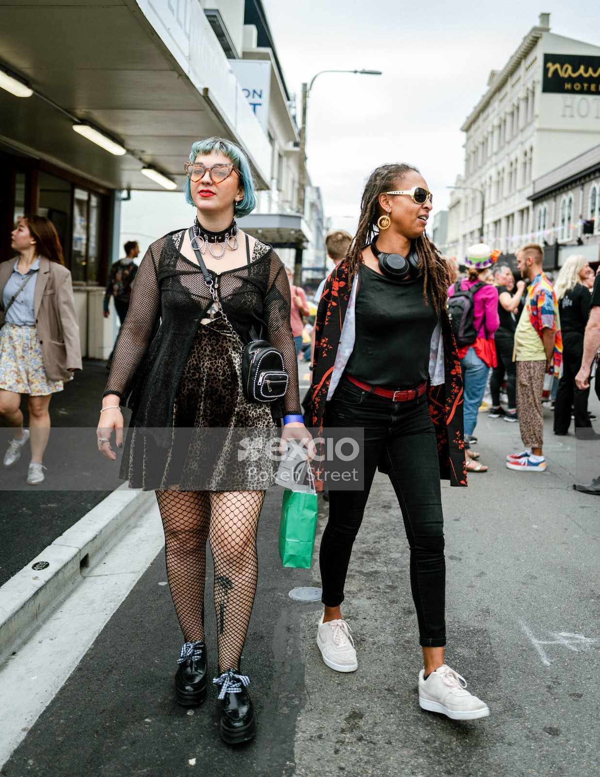 A white and black woman walk down Cuba street at Cuba Dupa 2021