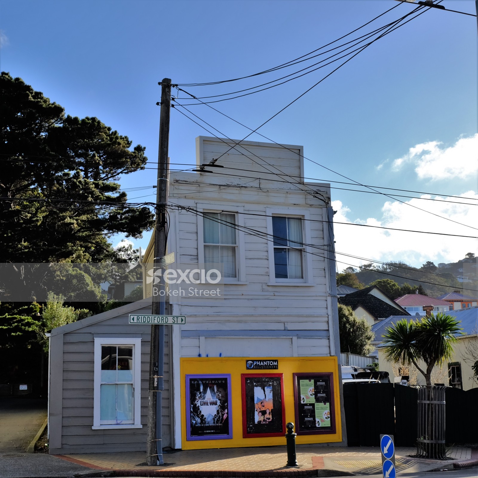 White wooden whare and advertisement board in Newtown
