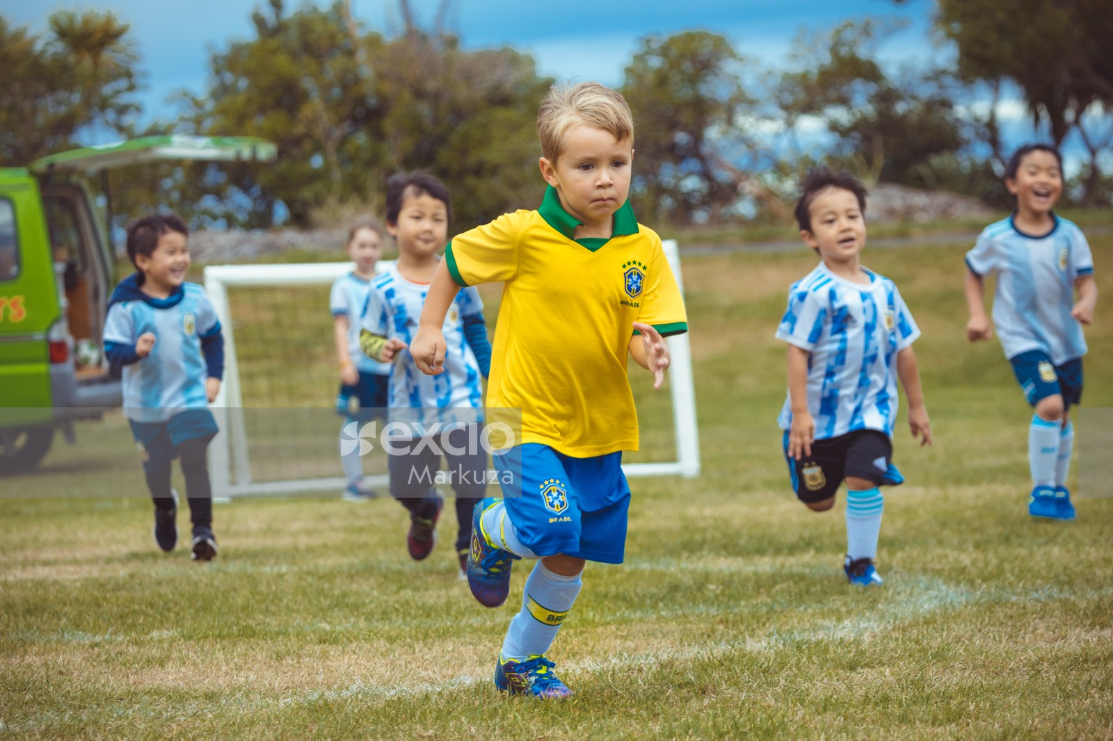 kids running towards football at Little Dribblers football exhibition