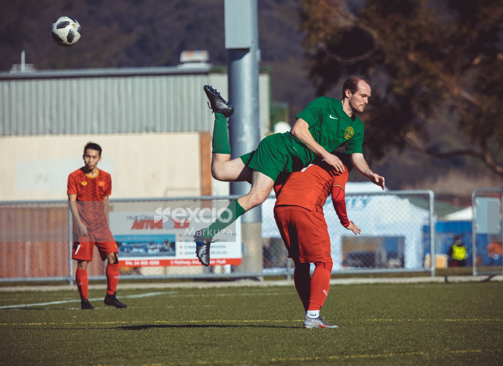 Player in green kit mounts opponent's shoulder during a jump - Sports Zone sunday league