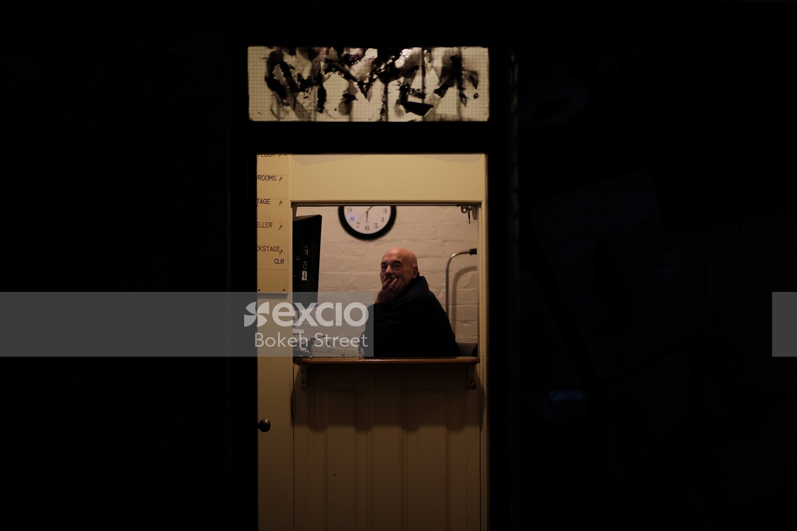 Bald man inside a building at the counter