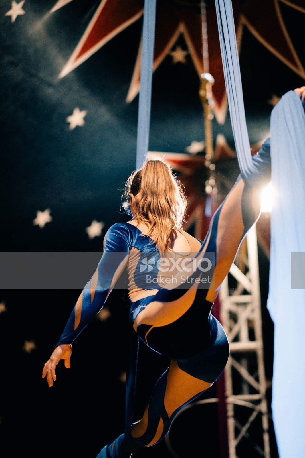 Female acrobat performing with cloth rope