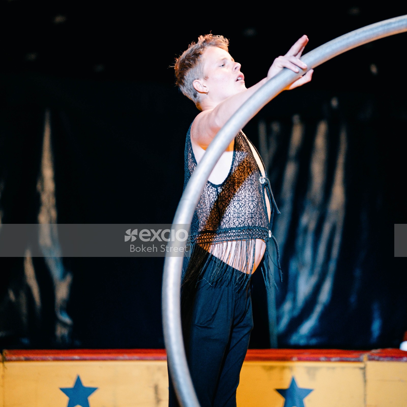 Male circus acrobat with a ring