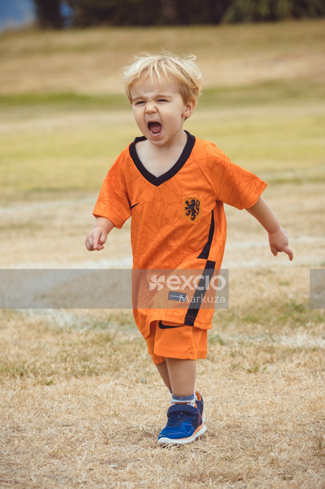 Blonde little boy in Netherland kit yelling at Little Dribblers sports contest