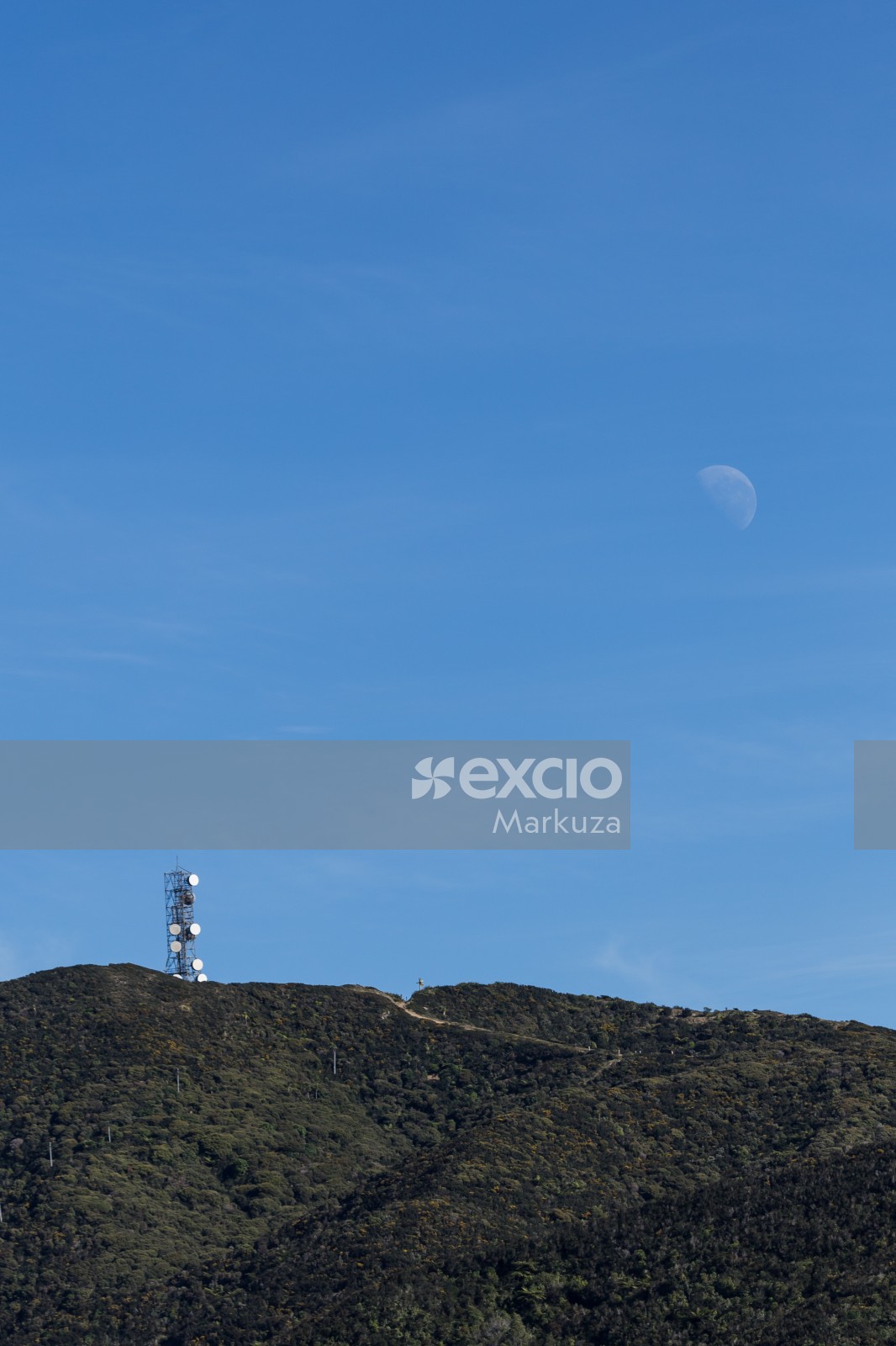 Communication tower on hill and moon