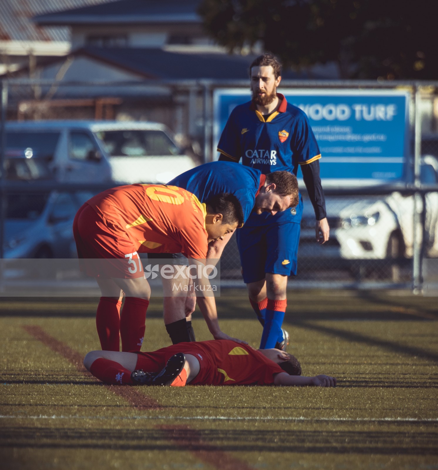 Injured player in red jersey lying on the ground - Sports Zone sunday league