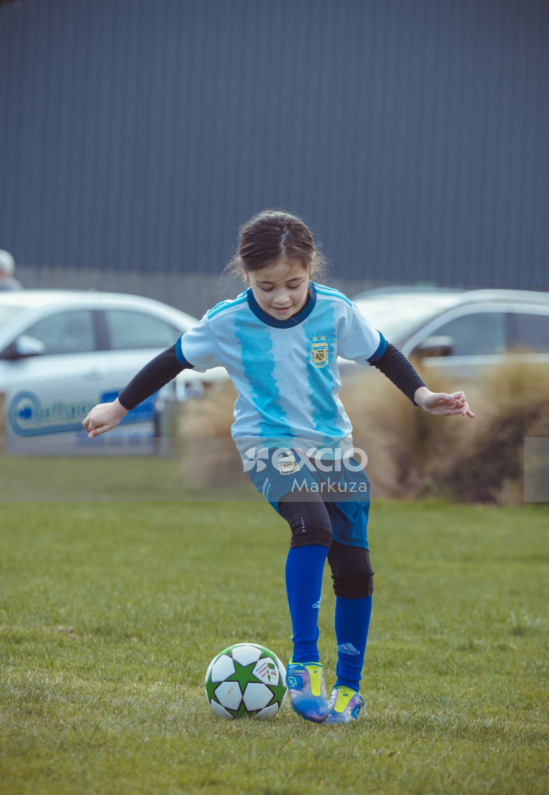 Girl dribbling football at Little Dribblers meet