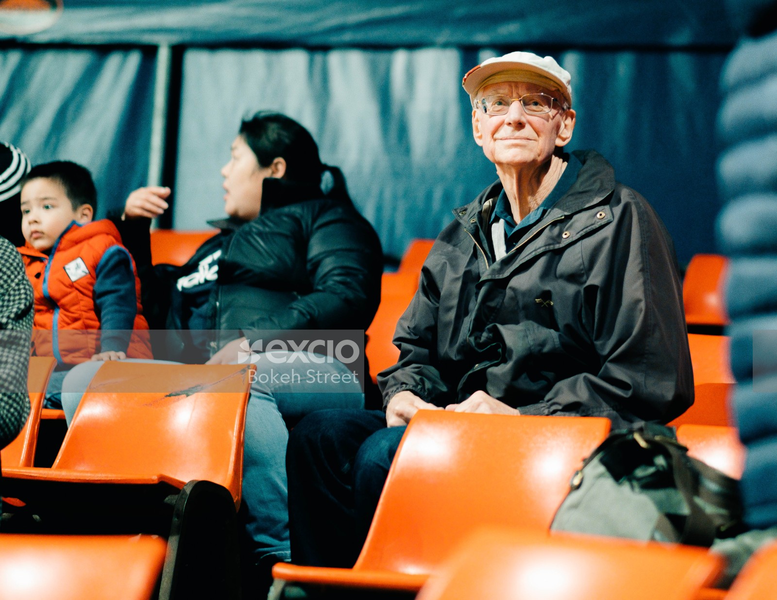 Old guy in audience sitting on orange seat