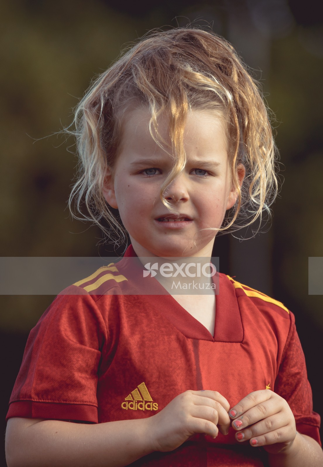 Girl in red shirt at Little Dribblers soccer match