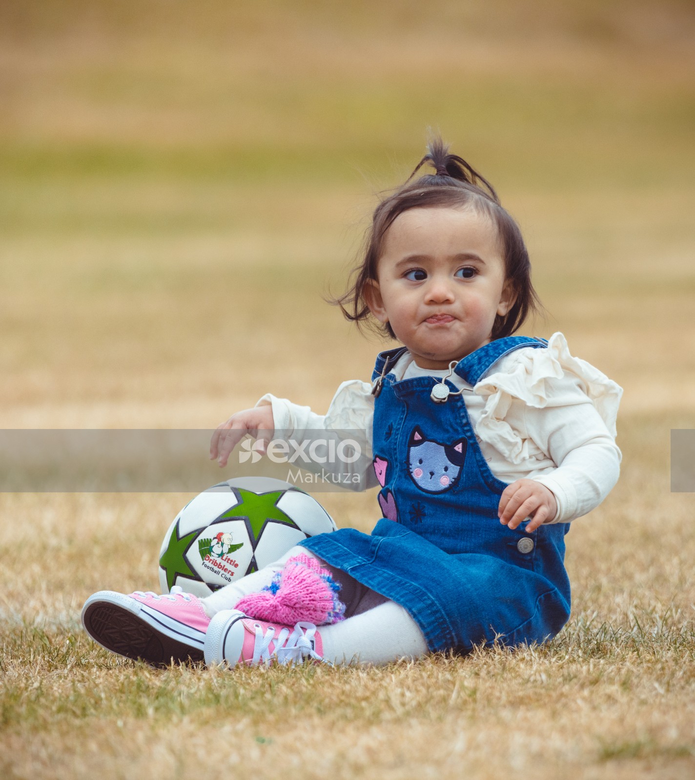Little girl in blue dungarees dress at Little Dribblers sports club