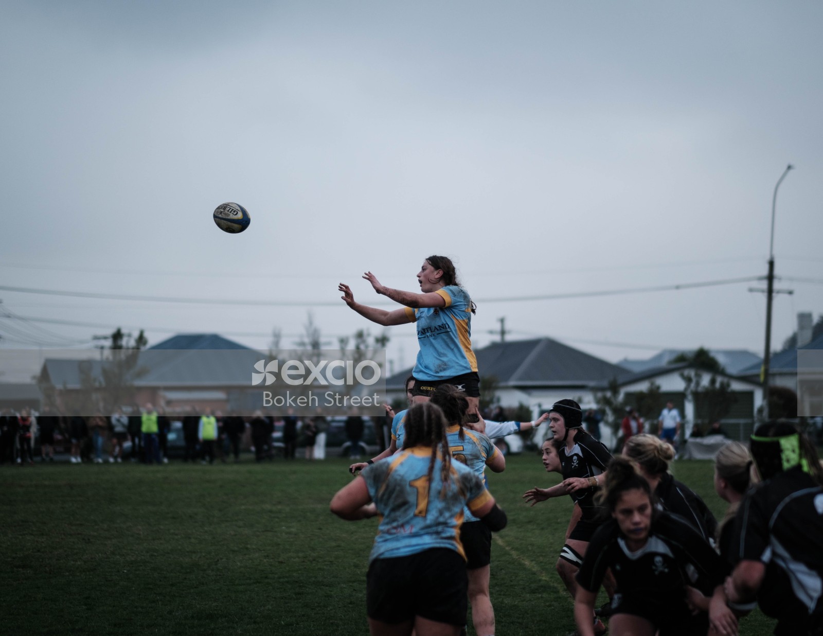 Women's rugby with ball in air