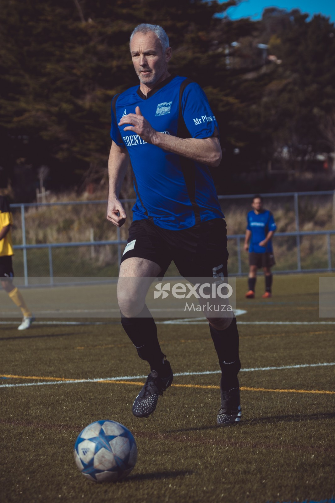 Old football player in blue shirt at a sports event - Sports Zone sunday league