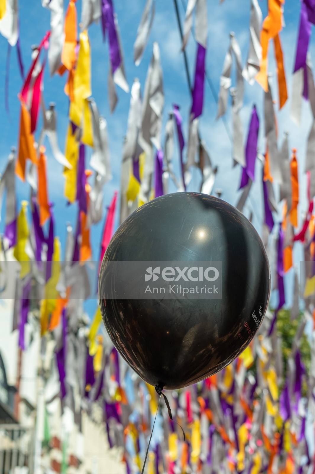 Black balloon in front of ribbons