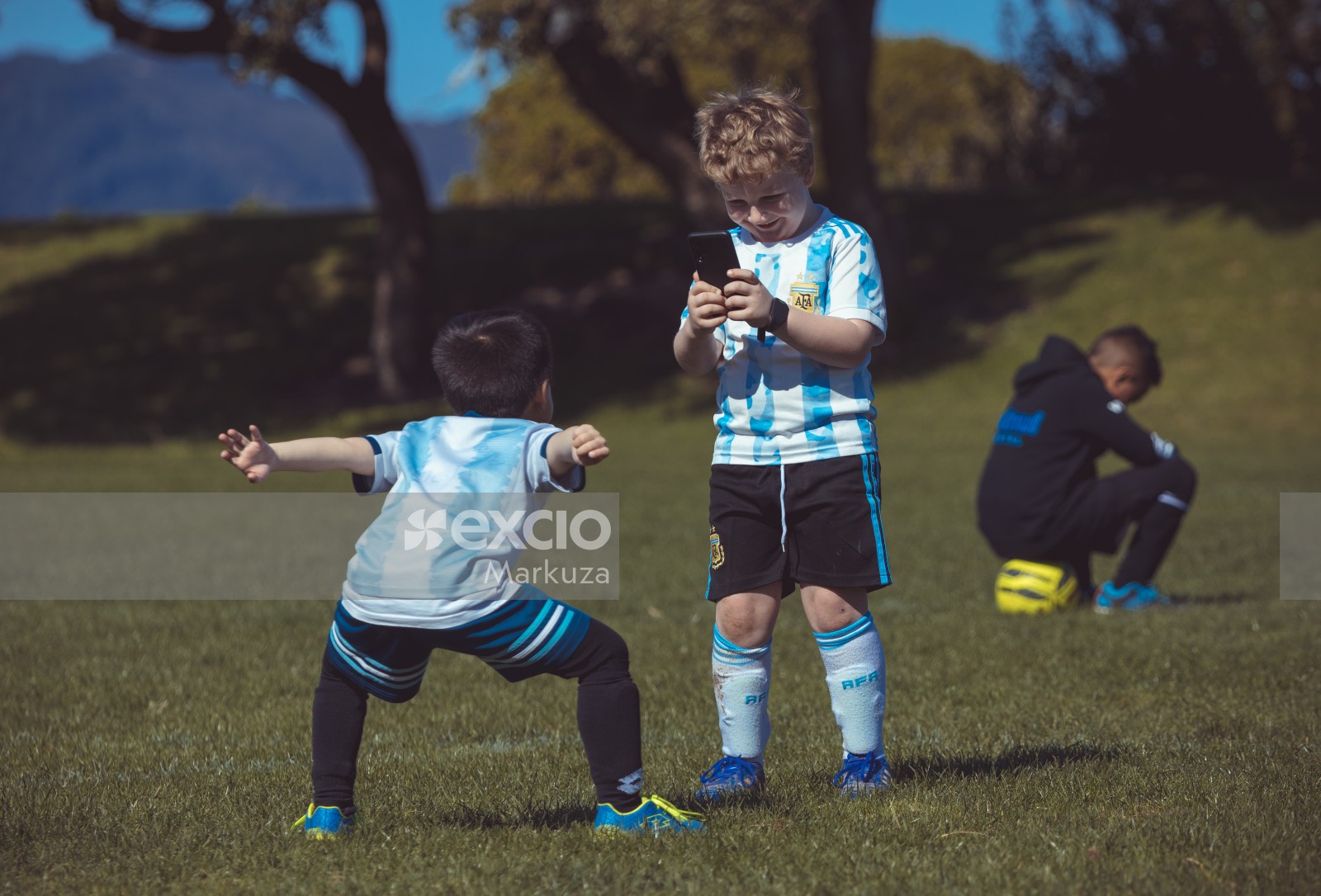 Kid taking picture of a teammate posing