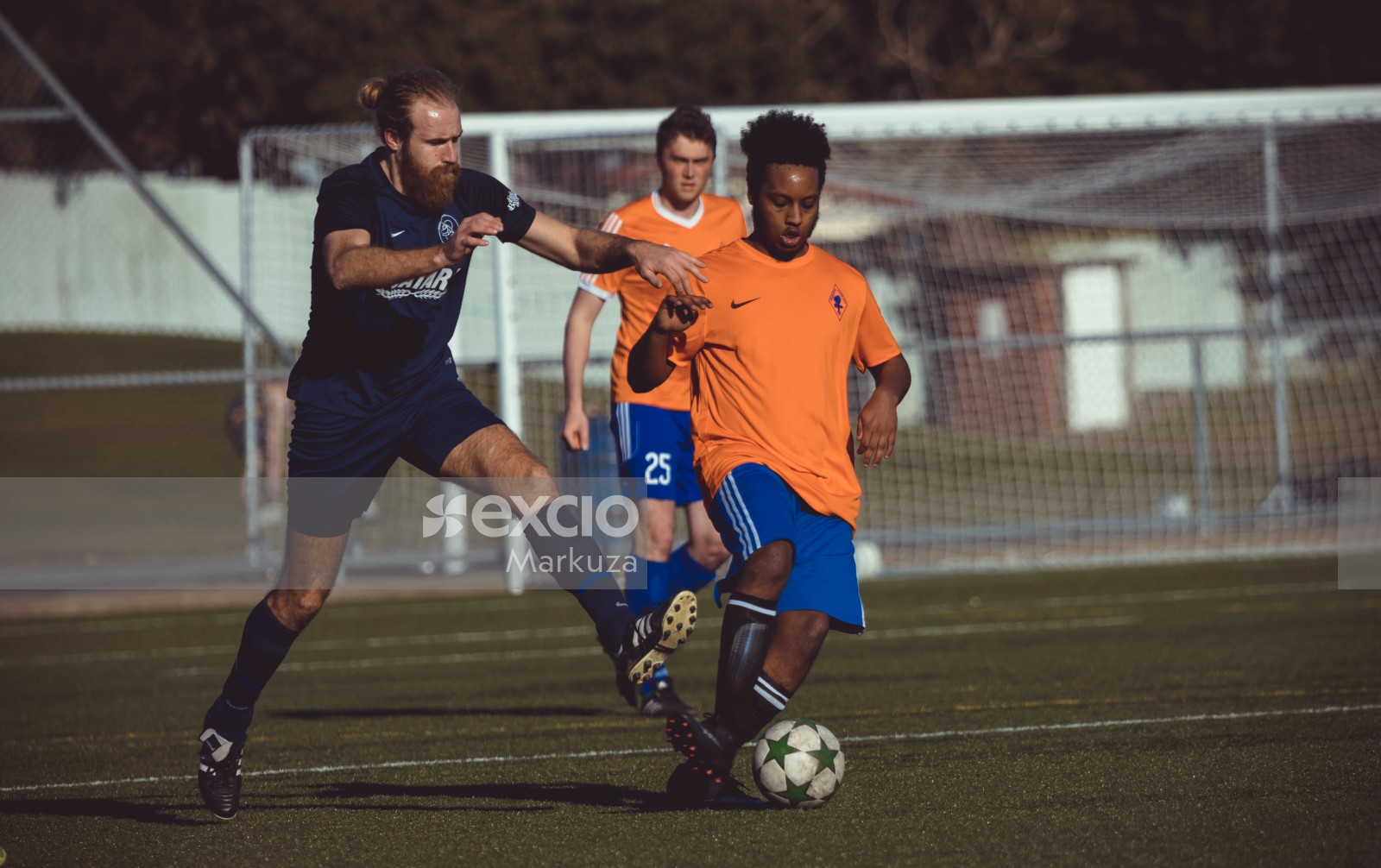 Dark skinned Phoenix FC player dribbling football - Sports Zone sunday league
