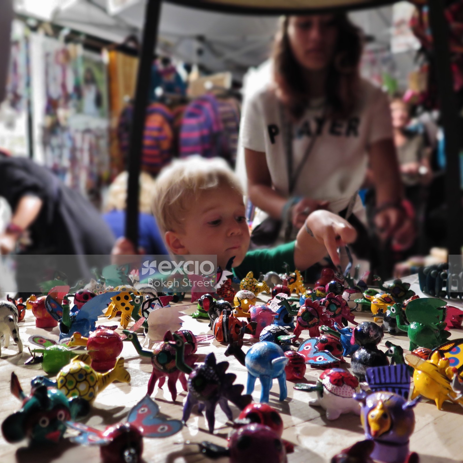 Child pointing at a toy at WOMAD festival