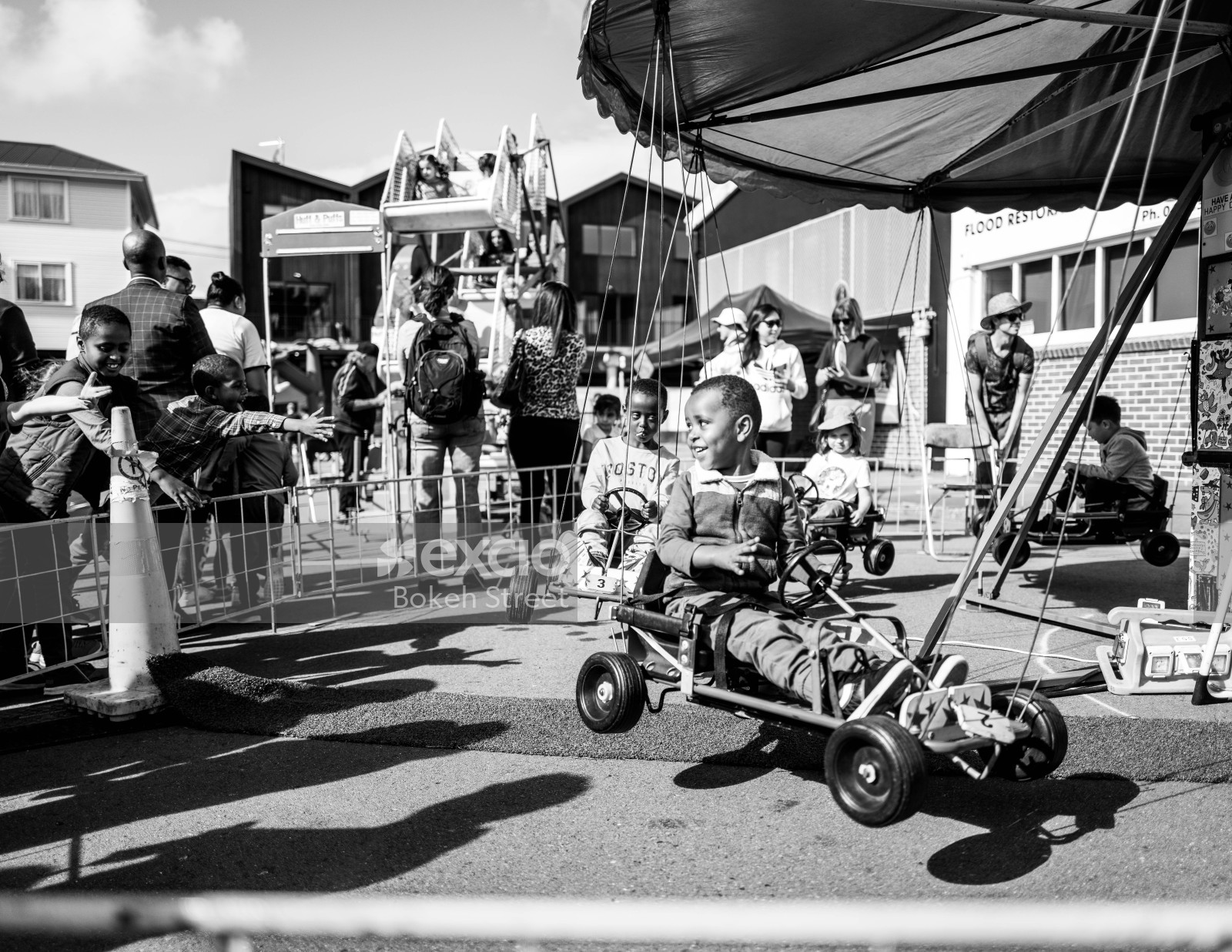 Kids on a carousel at Newtown festival 2021 black and white
