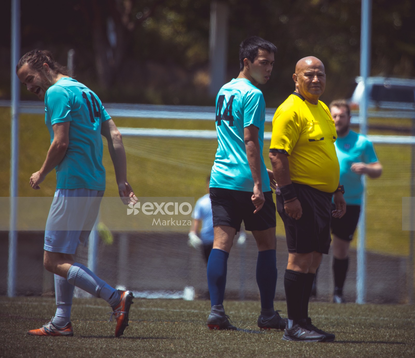 Bald referee wearing yellow shirt - Sports Zone sunday league
