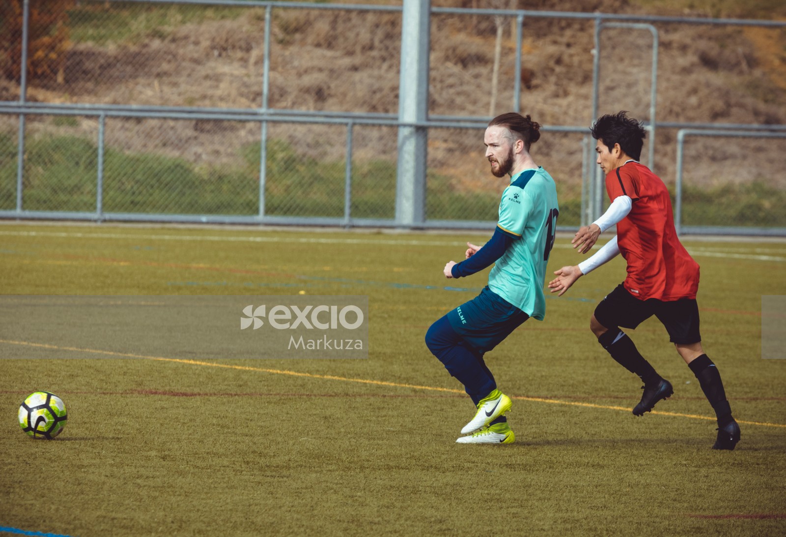 Player with man bun in turquoise shirt - Sports Zone sunday league
