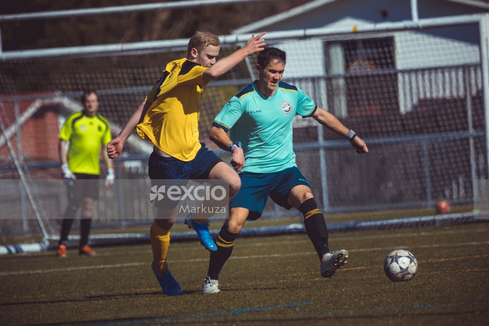 Player in turquoise shirt defending possession of the ball - Sports Zone sunday league