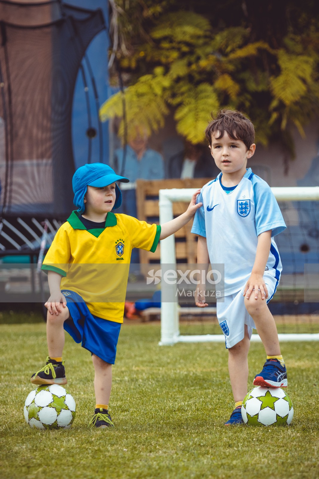 Kids wearing Argentine and Brasil kit posing with their footballs - Little Dribblers