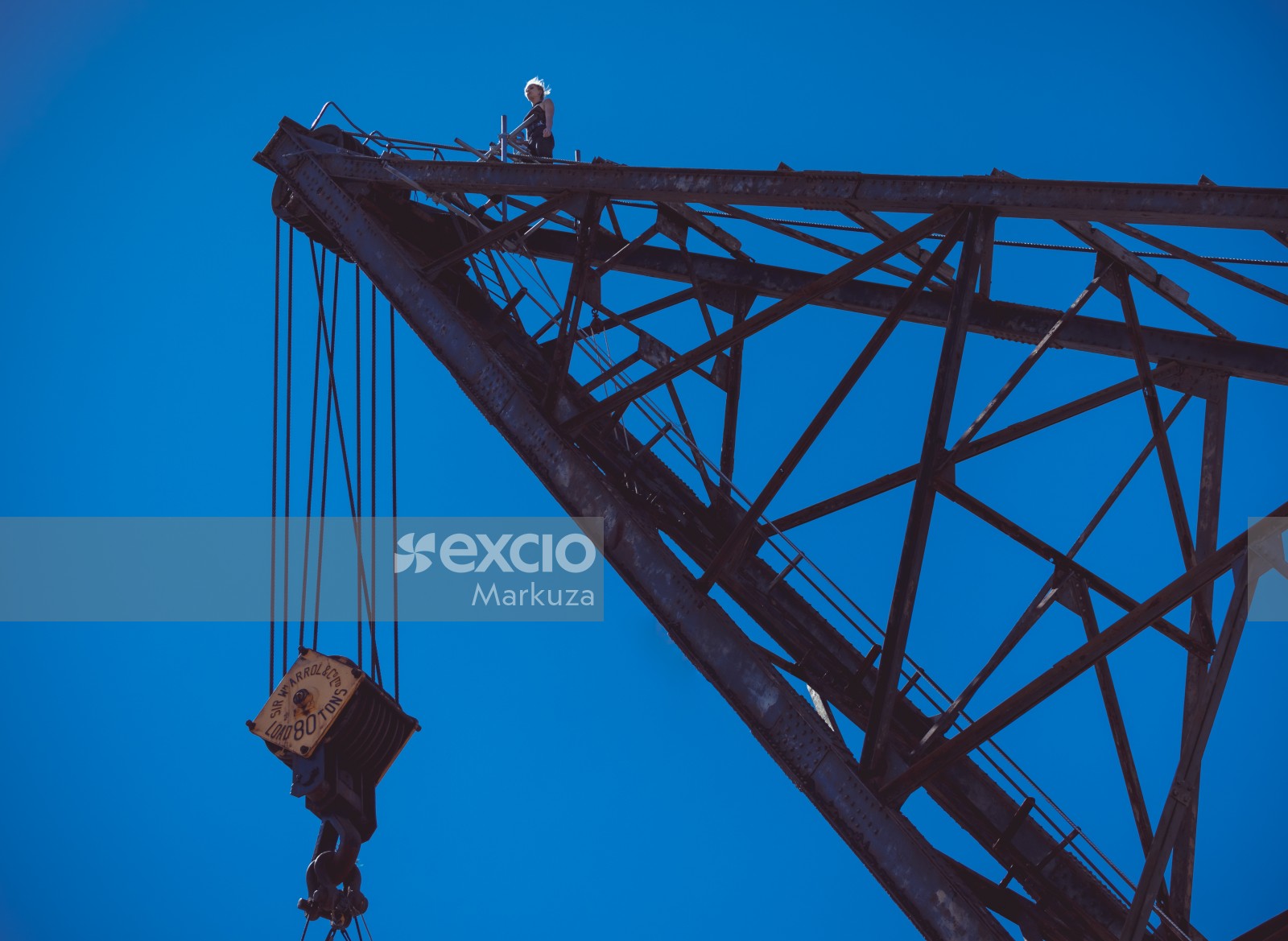 Female performer on top of a large crane