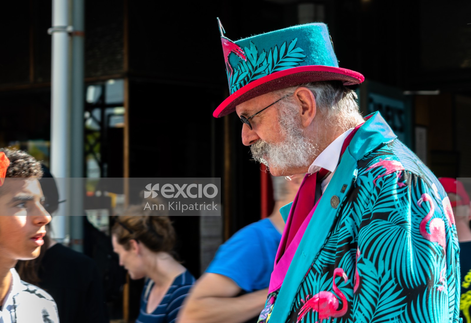 Man in tourquoise suit and hat