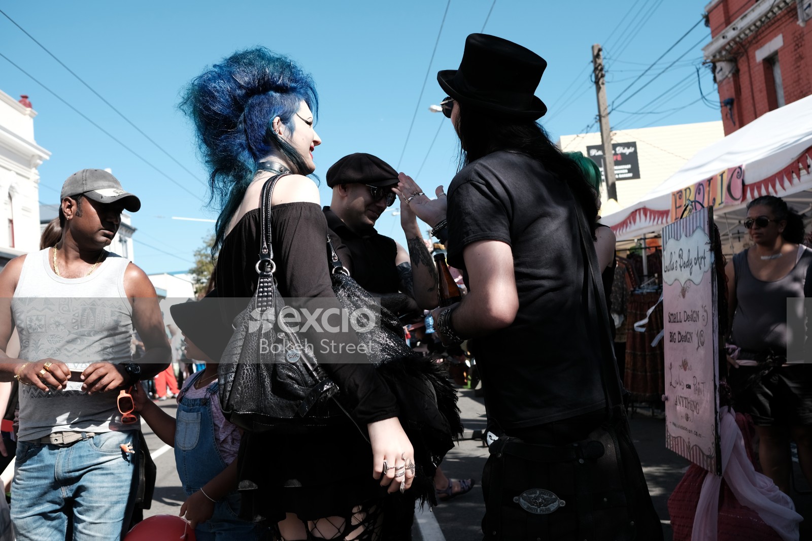 Blue haired pale woman in black attire at Newtown festival 2021
