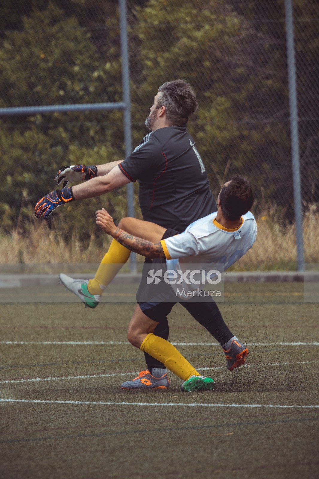 Player and goalkeeper battle to get the ball - Sports Zone sunday league