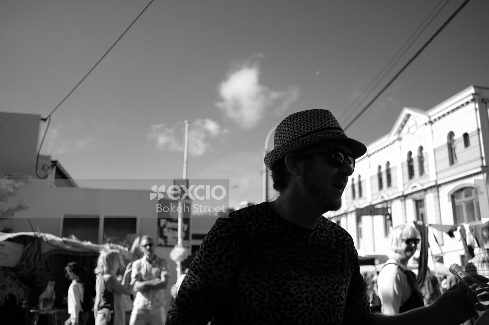 Man in a hat and cheetah print shirt at Newtown festival 2021 monochrome