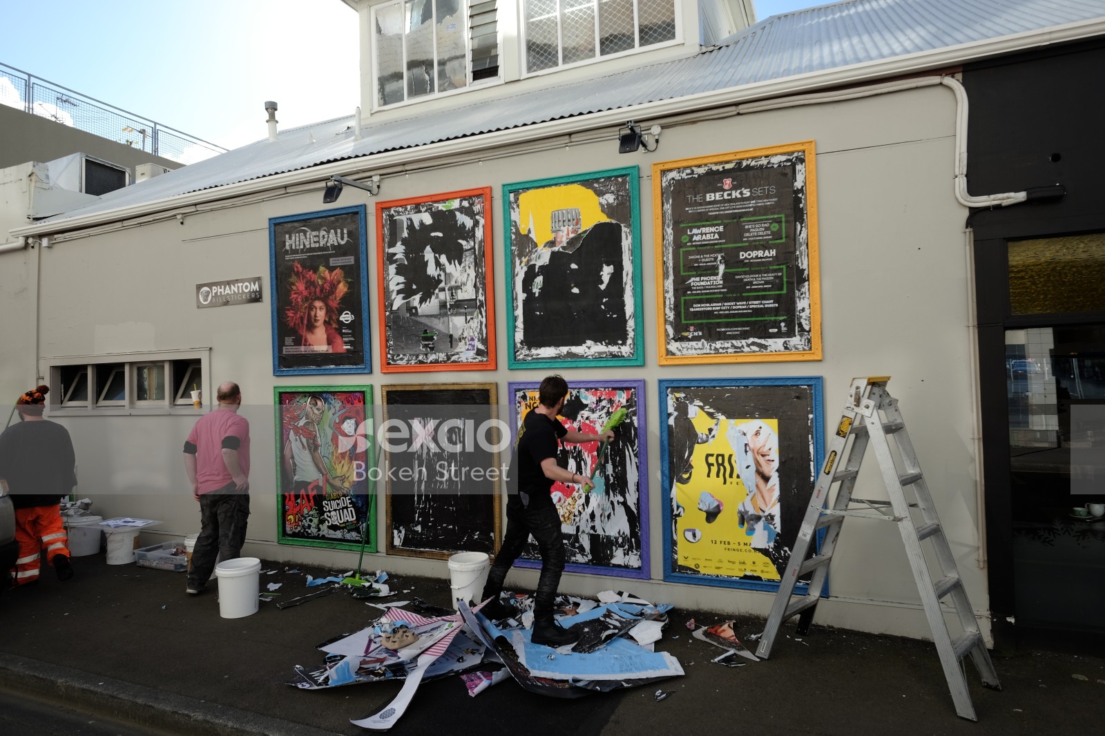 Posters being removed from a wall