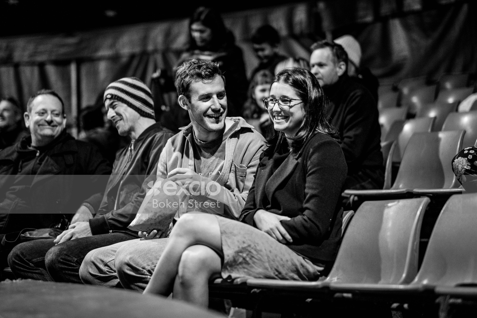 A couple at the circus enjoying a date candid black and white