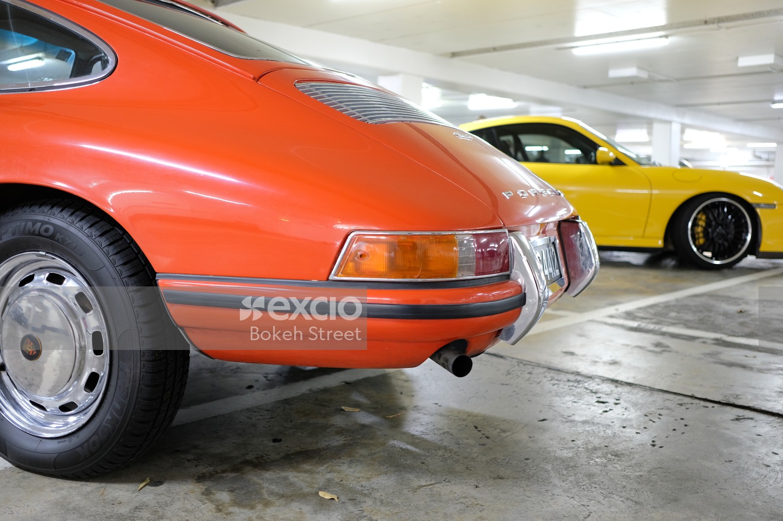 Classic orange Porsche 912 tail light and exhaust pipe