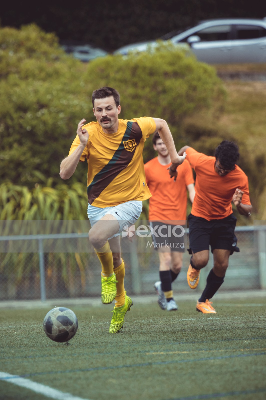 Player sprinting after a bouncing football - Sports Zone sunday league