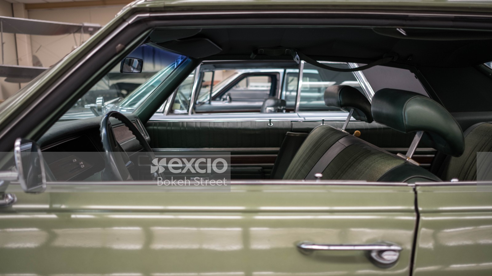 Side view of interior of a classic pillarless green car