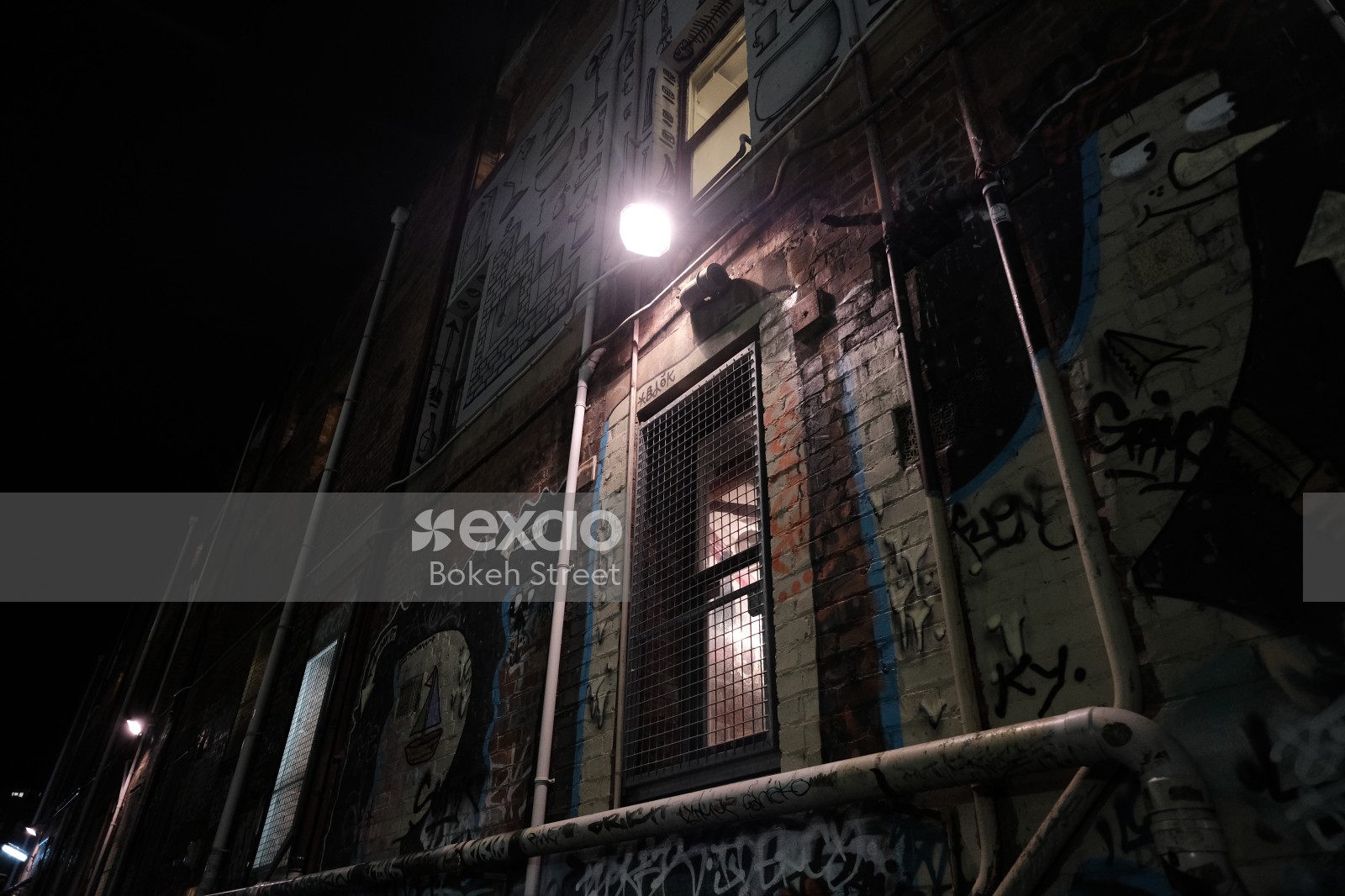 Graffitied building view at night