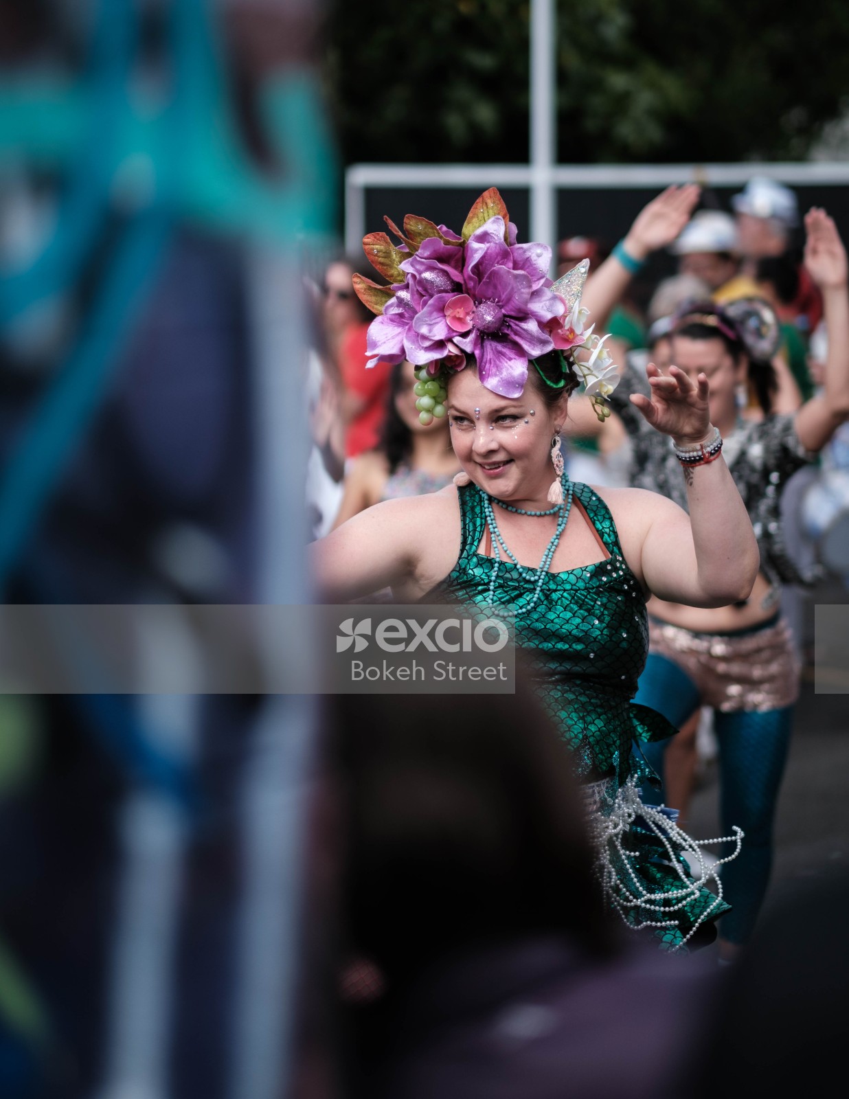 Woman in green dress and flower hat dancing at Aro valley Fair 2021