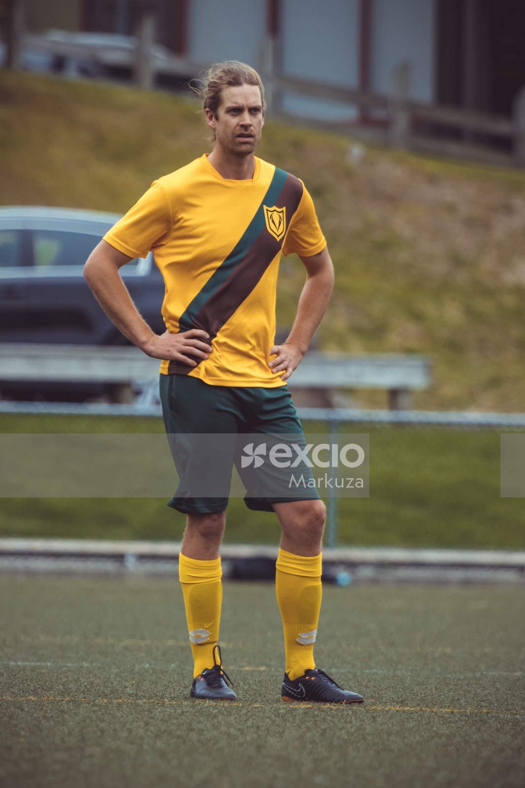 Football player in yellow shirt and green shorts portrait - Sports Zone sunday league