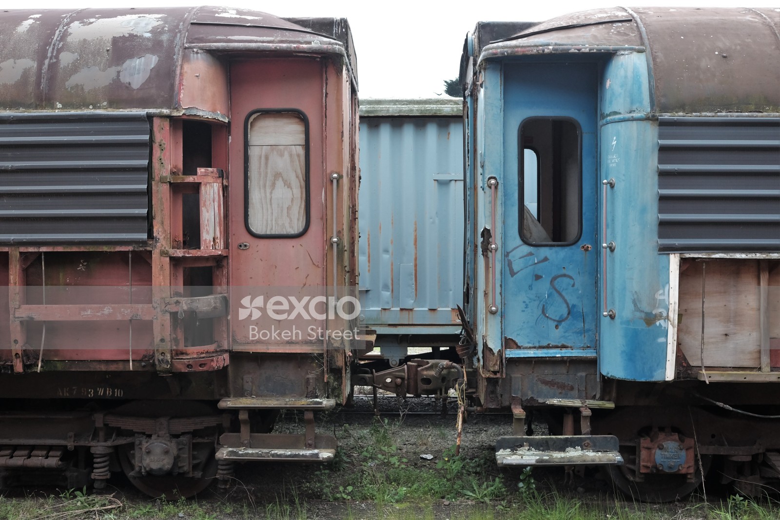 Abandoned old red and blue passenger bogies