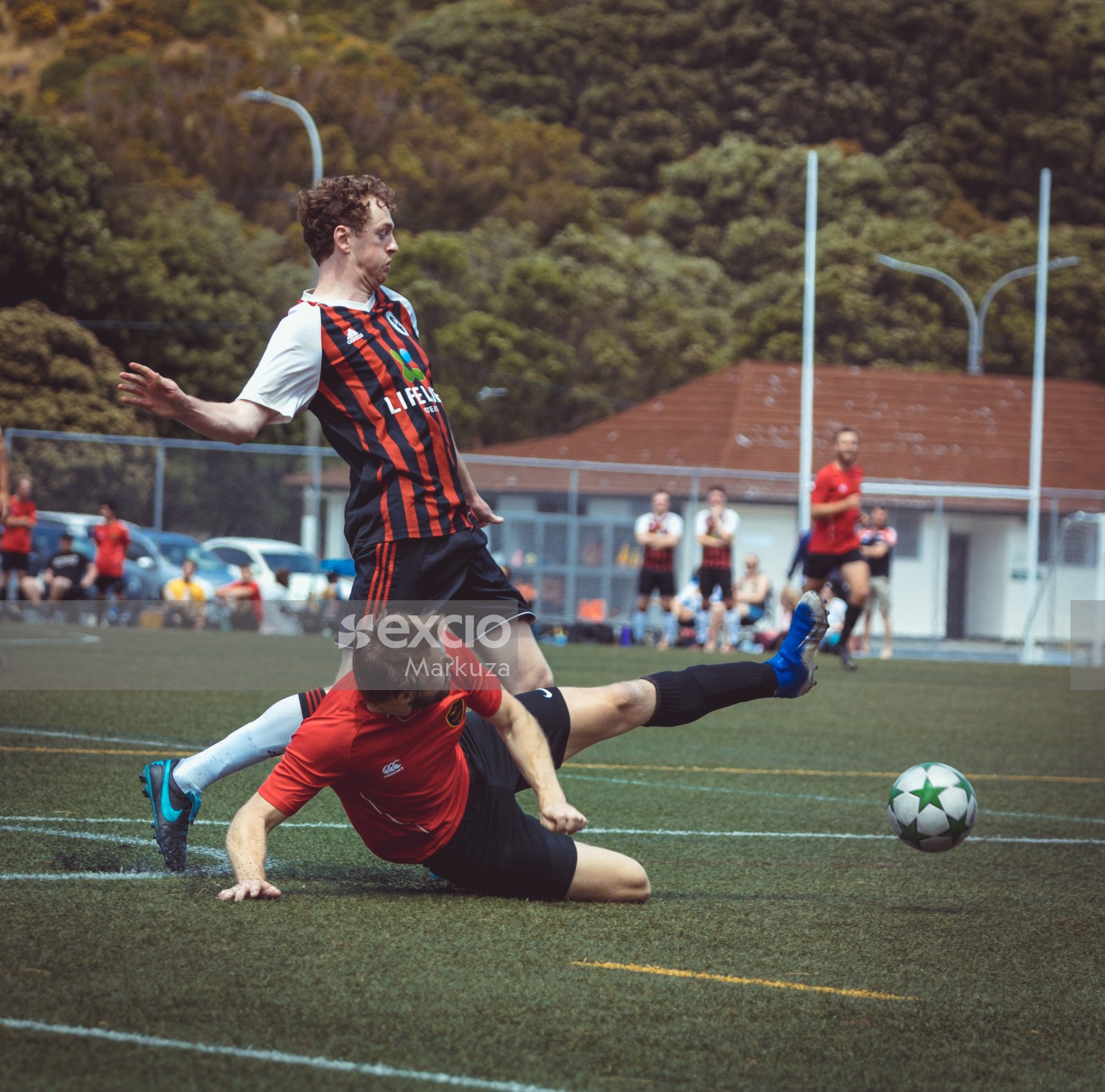 Island Bay United FC player slide tackle - Sports Zone sunday league