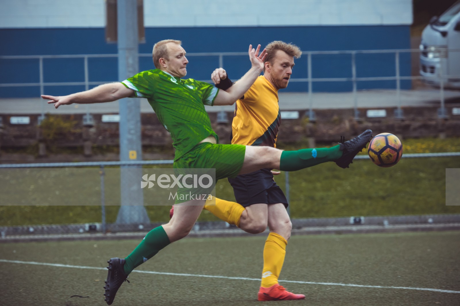 Football player in green kit trying for possession of football - Sports Zone sunday league